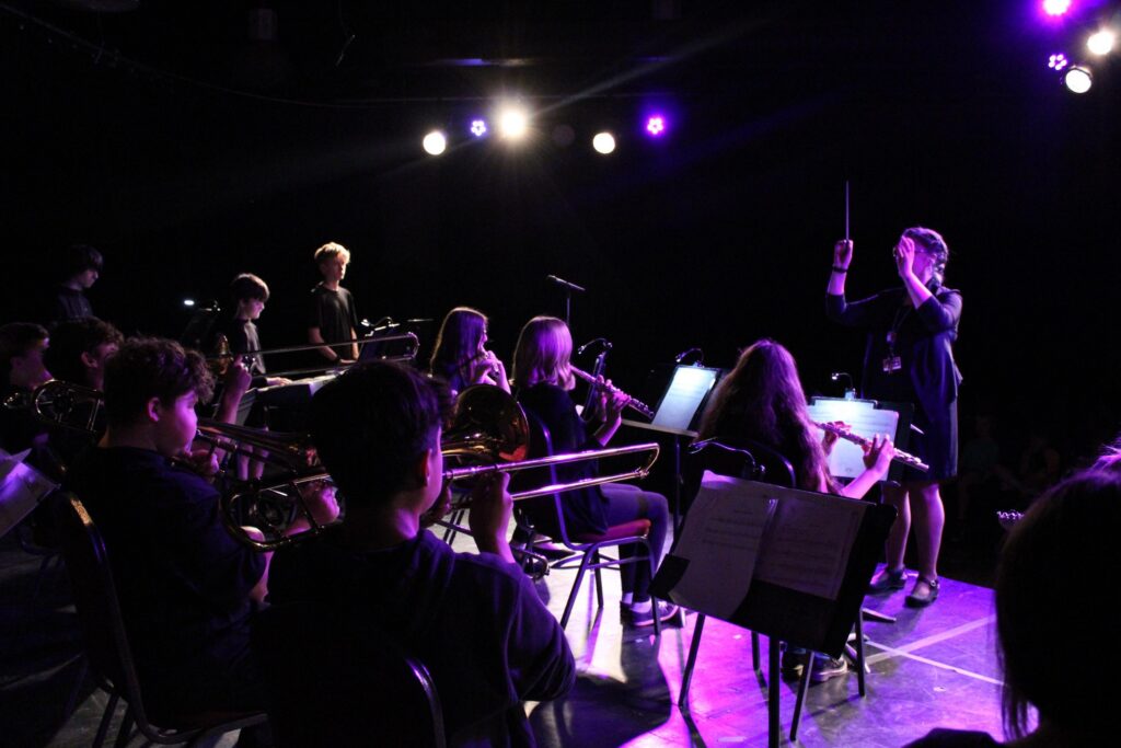 Students performing during a school band and music fundraiser concert